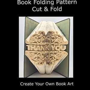 May include: A book folding pattern for a book art project. The pattern is for a book that will be folded to create a 3D design of the words "THANK YOU".