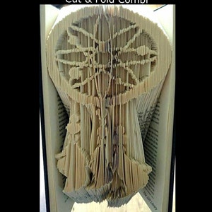 May include: A pattern for a folded book art project. The pattern is for a tree with a large trunk and branches that spread out. The text "Pattern Cut & Fold Combi" and "To Create your own Folded Book" is visible in the image.