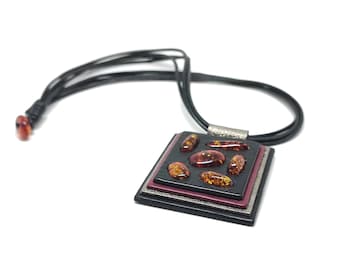 Handmade leather pendant with Baltic amber