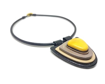 Handmade leather pendant with Baltic amber