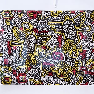 May include: A rectangular artwork with a black background, featuring a vibrant doodle design in yellow, red, and white. The artwork includes angel-like figures, coffee cups, and abstract shapes. The words "CAFE des ARTS" are visible.
