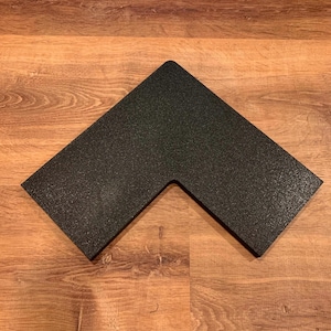 May include: Black rubber corner protector with a textured surface.