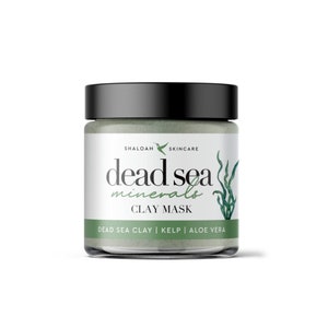May include: A white jar with a black lid and a green label that says "dead sea minerals clay mask" and "dead sea clay | kelp | aloe vera".