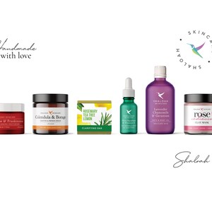 May include: A set of six natural skincare products from Shaloah Skincare. The products include a rose and frankincense anti-aging moisturizer, a calendula and borage soothing and repair cream, a rosemary, tea tree, and lemon clarifying bar, a rose radiance clay mask, a lavender, chamomile, and geranium bath and body oil, and a rosehip oil with vitamin E serum. The products are all packaged in white jars and bottles with black lids and labels.