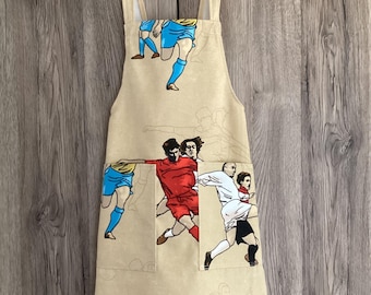 Football apron, 5-6 years. Beige, blue, red, orange football player cotton fabric. Cross back apron for kids with two pockets.