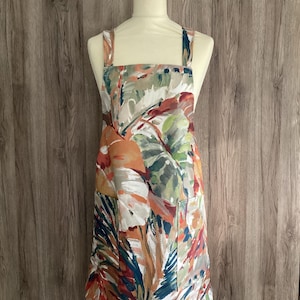 Medium, large cross back apron Cotton fabric. Palmyra, Prestigious Textiles. Large tropical leaves. Green, red white. Painted leaves