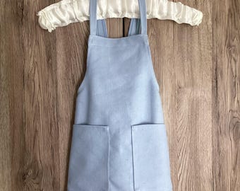 Toddler apron. 18 - 36 months. Light blue, hard wearing, thick and soft polyester no tie apron with two pockets. 1.5 - 3 years old.