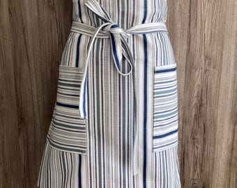 Striped half apron in blue, grey, off white. Wide apron, long straps, two pockets. Premium quality woven cotton fabric; Somerville Riviera.