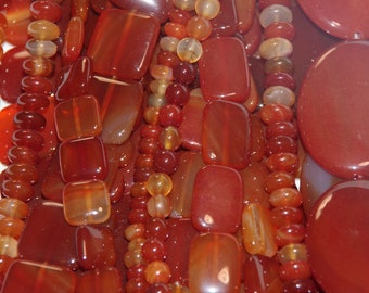 Carnellian- Oranges, Reds, Ambers make up the 8" half strands semi precious stone beads of various shapes