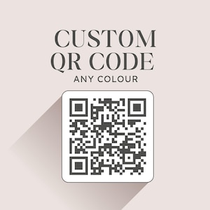 May include: A custom QR code graphic with the text "CUSTOM QR CODE ANY COLOUR". The QR code is black and white, set against a light background. The text "LOOKING FOR A CUSTOM QR CODE? SUPPLY YOUR URL + RECEIVE YOUR QR CODE IN ANY COLOUR BY PAPERFLORÉ" is also included.