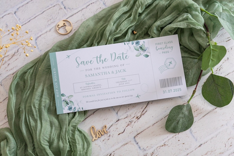 May include: A save the date card designed to look like an airline boarding pass. The card is white with green foliage and text that reads "Save the Date" for the wedding of Samantha & Jack. The date is listed as Thursday, 31 July 2025. The card also includes the location of the wedding, St. Sophia Chapel, Rhodes, Greece.