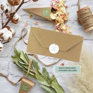 May include: Rustic brown envelopes with a green and white floral save the date sticker. The text on the sticker reads "Save the Date". The text "Rustic Envelopes + Stickers Included" is printed on a green rectangle.
