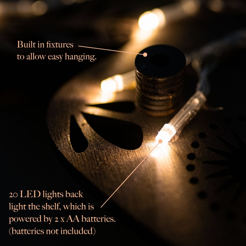 May include: Dark brown wooden shelf with 20 warm-white LED lights. Built-in fixtures allow for easy hanging.  The shelf is powered by 2 AA batteries (not included).