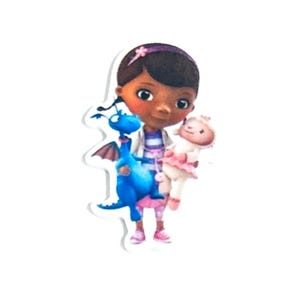 May include: A die-cut sticker featuring a cartoon character with dark skin, wearing a white coat over a striped shirt, holding a blue dragon and a white lamb. The character has a purple headband and pink shoes.