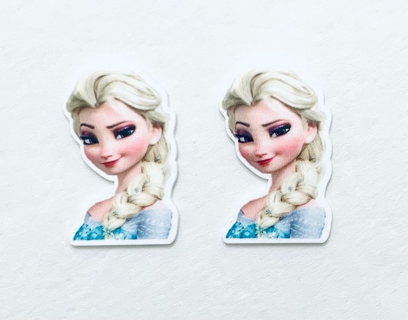 May include: Two printed images of Elsa from the movie Frozen. Elsa is wearing a blue and white dress with a braid in her hair. She has a light blue background.