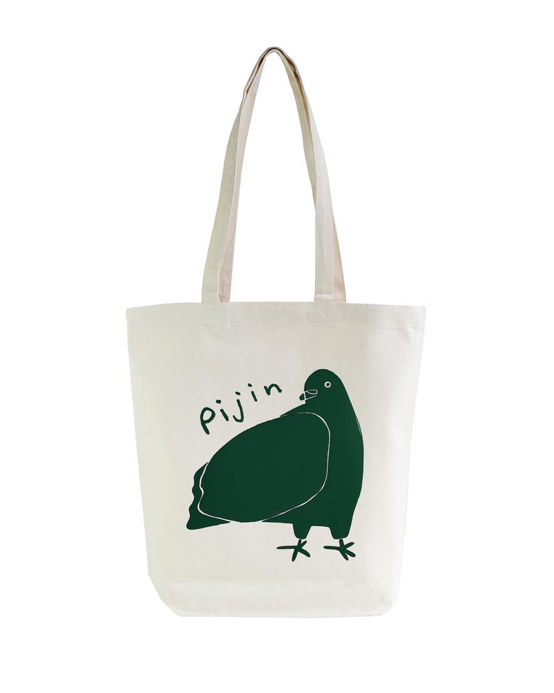 May include: A white canvas tote bag with a green illustration of a pigeon and the word "Pijin" printed on the front.