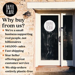 May include: A brick building with a glass door that has a white circle with the text "PAPER PLANE" on it. The text "Why buy from us?" is on the wall next to the door, along with a list of reasons to buy from this business, including "We're a small business supporting real people, not billionaires", "140,000+ sales", "Fast shipping", "Star Seller offering great customer service", and "We ship orders entirely plastic-free".