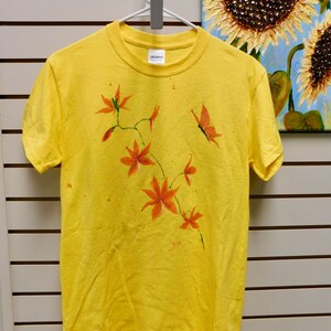 Orange Orchids hand painted on a yellow tee shirt by master artist Jennifer Ann Meade