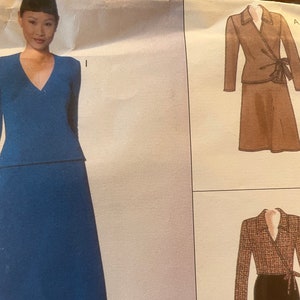May include: A sewing pattern for a wrap dress and skirt. The pattern includes two different styles, one with a brown skirt and one with a black skirt. The pattern is labeled with the letters "A" and "P".