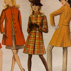 May include: An illustration of three coats. The left is a solid orange coat with buttons. The center is a plaid coat in orange, yellow, and white with a brown hat. The right is a mustard yellow coat with a belt detail. Each coat has a collar.