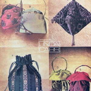 May include: Six different styles of small, decorative bags. The bags are made of various fabrics, including velvet, silk, and brocade. The bags are in a variety of colors, including red, green, black, and purple. The bags are all designed by Linda Carr.