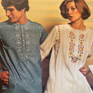 May include: Two people wearing embroidered shirts. The person on the left is wearing a blue shirt with white embroidery. The person on the right is wearing a white shirt with red, yellow, and black embroidery.