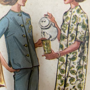 May include: Two women in vintage clothing, one wearing a blue button-up shirt and shorts, the other wearing a white dress with green floral print. The woman in the blue shirt is holding a white teapot and a small container.