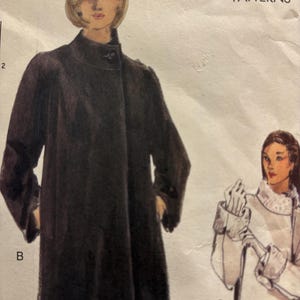 May include: A Vogue Patterns sewing pattern envelope featuring illustrations of two coats. One is a long, dark brown coat with a high collar and button closure labeled B. The other is a light-colored coat with fur-like trim labeled C.