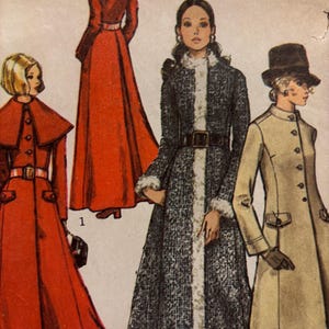 May include: A sewing pattern illustration featuring three coats. One is a long red coat with a capelet and belt. Another is a dark textured coat with white fur trim and a belt. The third is a beige knee-length coat with buttons and a hat.