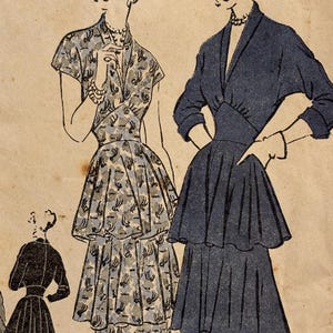 May include: Two women wearing vintage dresses with multiple layers of ruffles. The dress on the left is a floral print and the dress on the right is a solid dark blue.