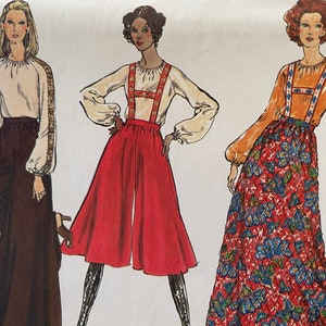 May include: A vintage sewing pattern featuring three women's outfits. The first outfit is a white blouse with brown trousers. The second outfit is a white blouse with red culottes and suspenders. The third outfit is a long orange blouse with a floral print skirt.