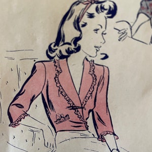 May include: A vintage illustration of a woman wearing a pink jacket with a ruffled collar and cuffs. The jacket has a button closure and a pocket on the front. The woman has dark hair styled in a curled bob and is wearing a headband.