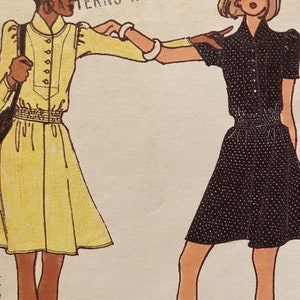 May include: Two women's dresses, one yellow with a button-up front and the other black with white polka dots. Both dresses have short sleeves and a cinched waist.