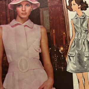 May include: A light pink sleeveless dress with a collared neckline, a wide matching belt with a large oval buckle, and two front pockets with button closures. Beside it is a fashion illustration of a similar dress with the text Jean Pa.
