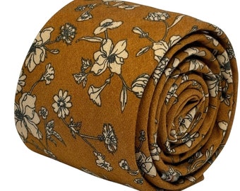 May include: A brown tie with a white floral pattern. The tie is rolled up and the floral pattern is visible on the outside of the roll.