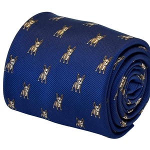 May include: A blue silk tie with a repeating pattern of brown French Bulldogs.
