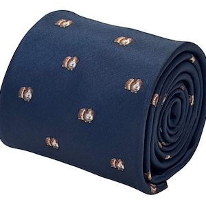 May include: Rolled navy blue tie featuring a repeating pattern of small, detailed guinea pig illustrations in shades of brown and white. The tie is made of a smooth fabric and is rolled up, showcasing the pattern.
