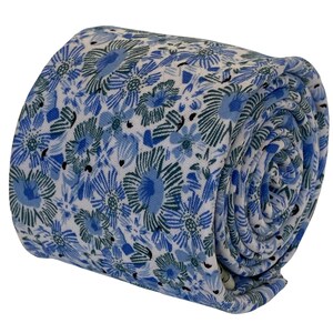 May include: A white tie with a blue and green floral pattern. The tie is rolled up and the pattern is visible on the outside of the roll.