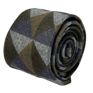 May include: A rolled up tie with a geometric pattern in shades of gray, brown, and blue.