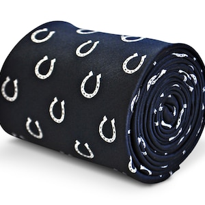 May include: A dark blue necktie with a white horseshoe pattern.