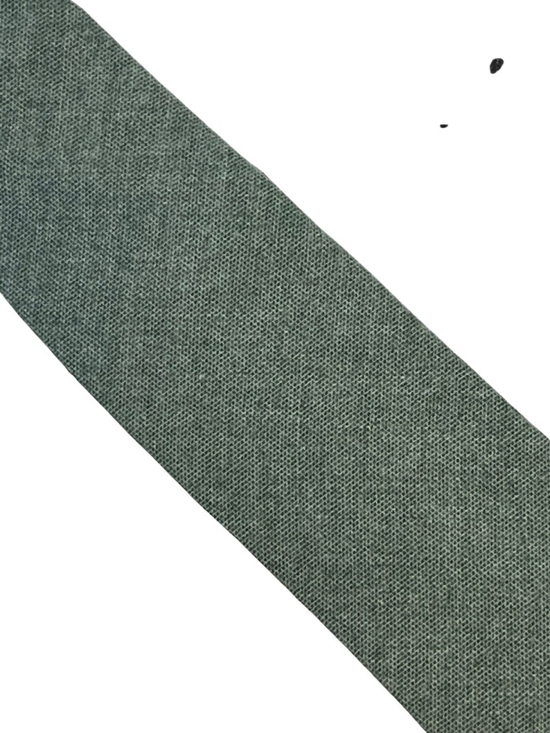 May include: A dark green fabric tie with a textured weave.