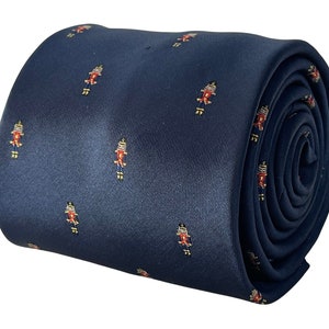 May include: A navy blue silk tie with a repeating pattern of red, yellow, and white nutcracker figures.