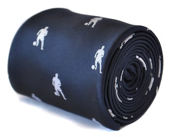 May include: A dark blue necktie with a white silhouette of a soccer player repeated throughout the fabric.