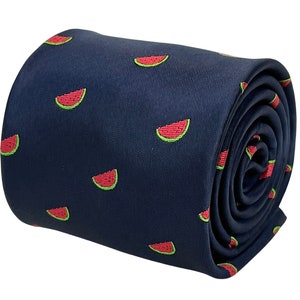 May include: A dark blue necktie with a repeating pattern of red watermelon slices.