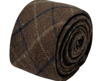 May include: A brown wool tie with a blue and orange plaid pattern. The tie is rolled up and ready to be worn.