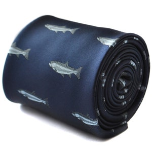 May include: A navy blue silk tie with a repeating pattern of silver fish.
