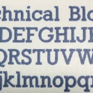 May include: A close-up of a white surface with the text "Technical Block" in dark blue, followed by the uppercase and lowercase alphabet in a serif font. The letters are evenly spaced and clearly printed.