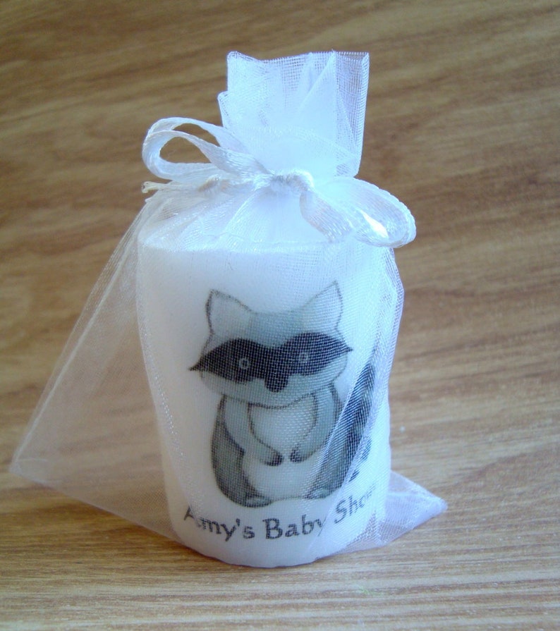 Close up of raccoon candle in organza bag