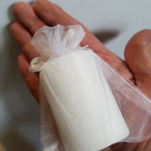 Baby shower candle held in hand to show size