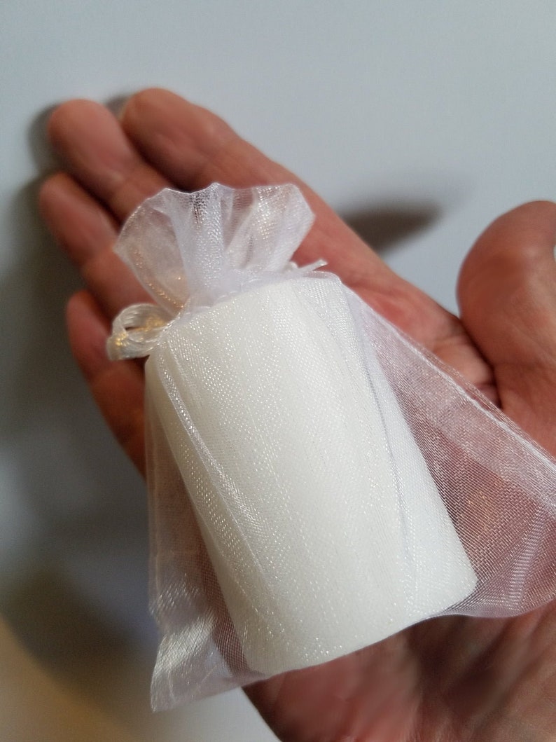 Baby shower candle held in hand to show size